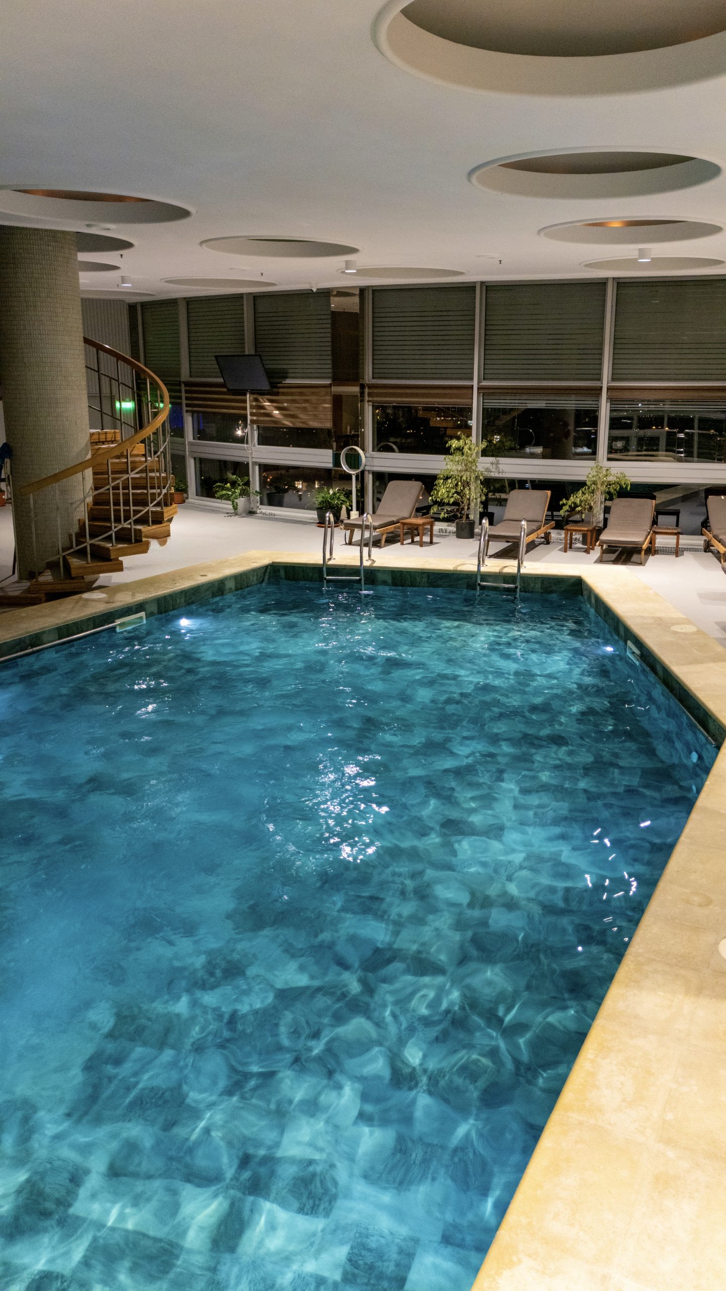 Swimming pool with loungers
